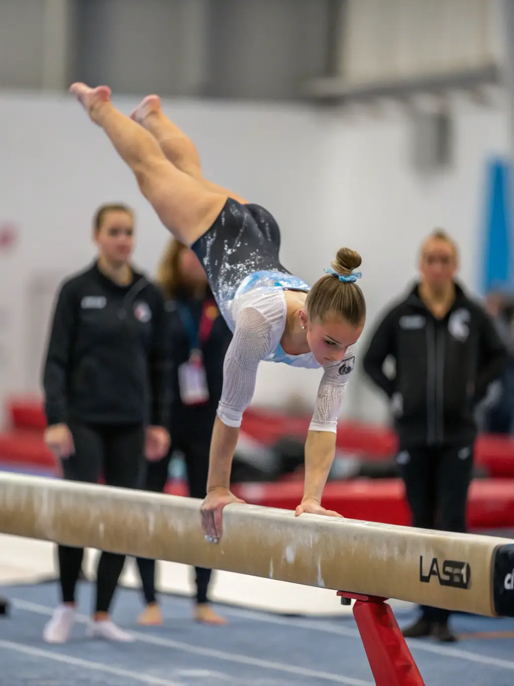 A gymnast successfully completing a challenging routine, demonstrating the personal development and skill enhancement opportunities available at Pertuis Gymnastique.